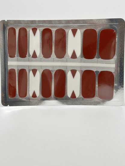 Red geometric nail wraps sheet with triangular cutout patterns in packaging