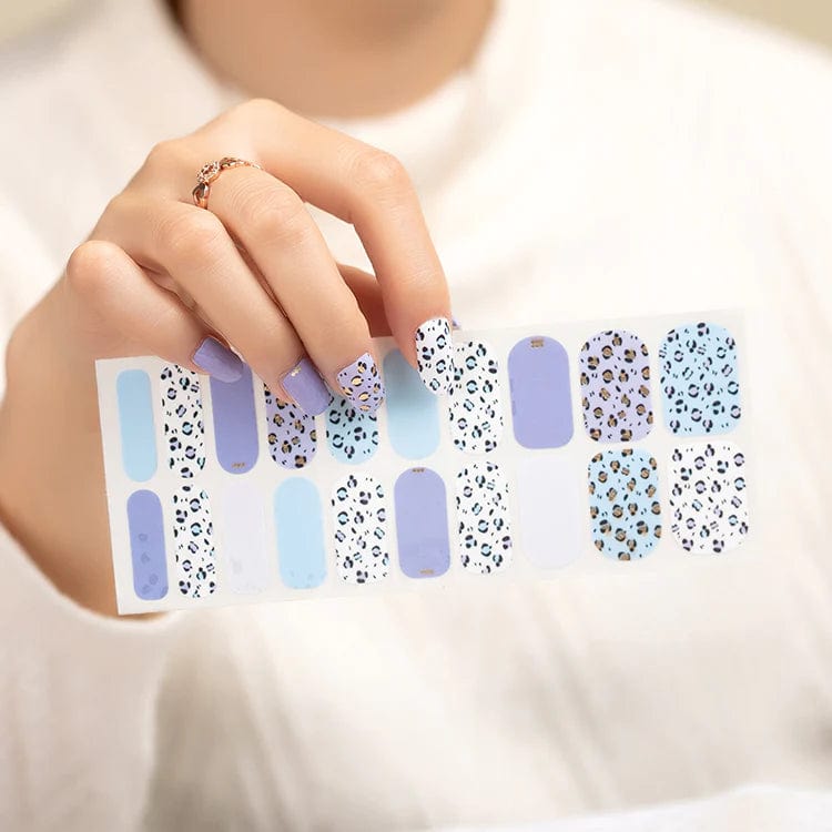 Blue and white leopard print nail wraps sheet showing multiple designs for DIY manicure application