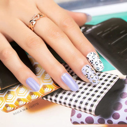 Lilac nail wraps with white leopard print accent nails, gold stud detailing, glossy finish