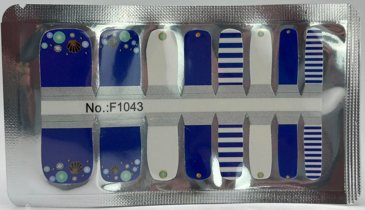 Blue and white striped pedicure nail wraps with beach themed dots and shells