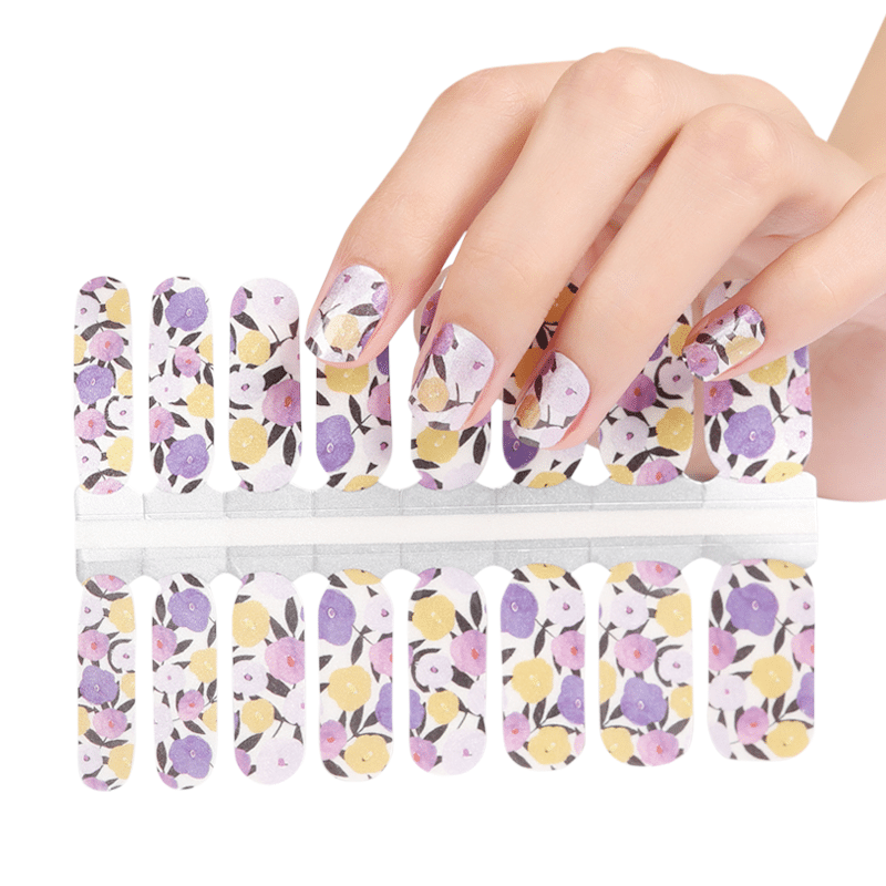Holy Classics nail wraps with purple, pink and yellow floral pattern on white base