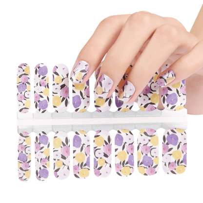 Holy Classics nail wraps with purple, pink and yellow floral pattern on white base