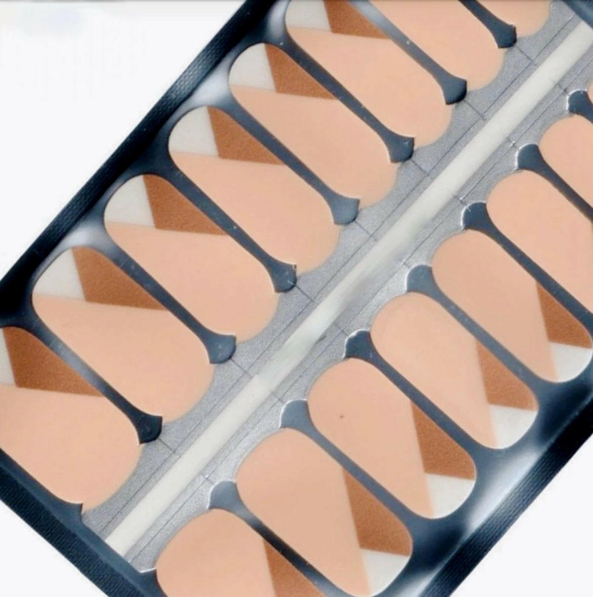 Pink and gold geometric nail wraps in packaging showing modern nail art design