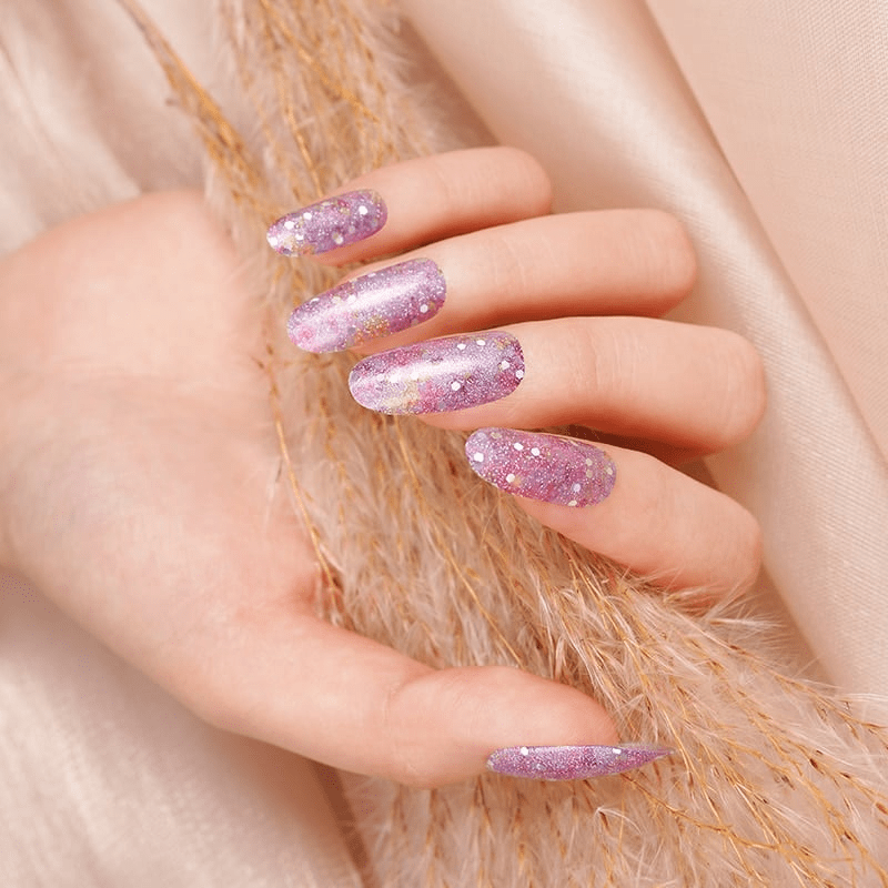 Purple glitter nail wraps with scattered white dots, glossy almond-shaped finish