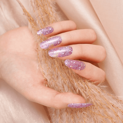 Purple glitter nail wraps with scattered white dots, glossy almond-shaped finish