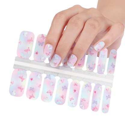 Hand holding pink butterfly nail wraps sheet with gradient background design