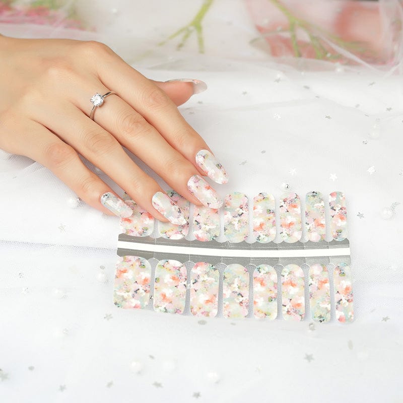 Pink cherry blossom nail wraps on hand with floral pattern classic design