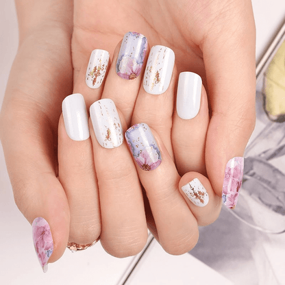 Floral nail wraps manicure on hands with pink purple watercolour blossom design