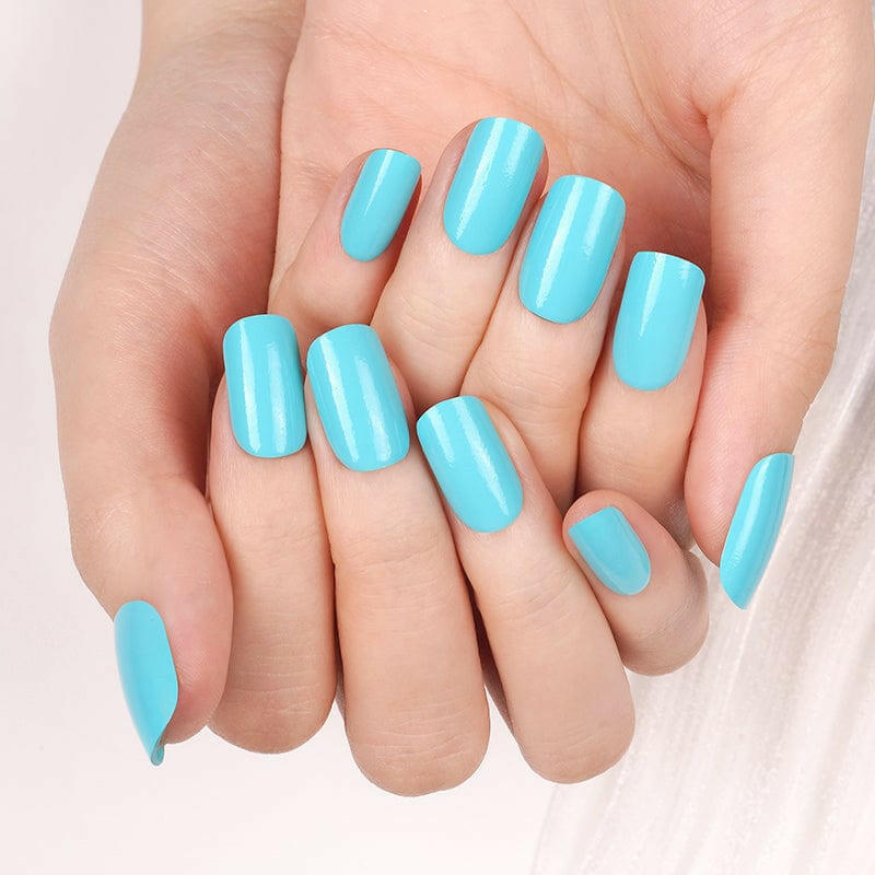 Glossy turquoise blue Holy Classics nail wraps in a solid colour on medium-length nails
