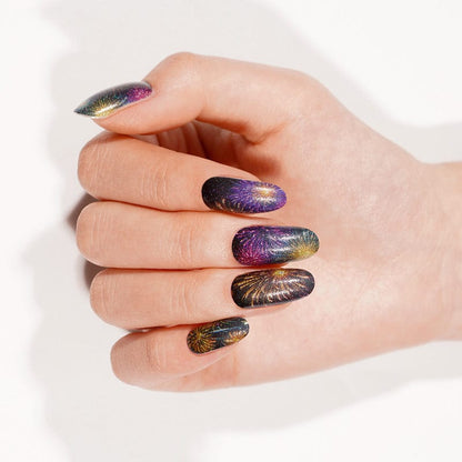 Black nail wraps with purple, gold and teal firework burst design