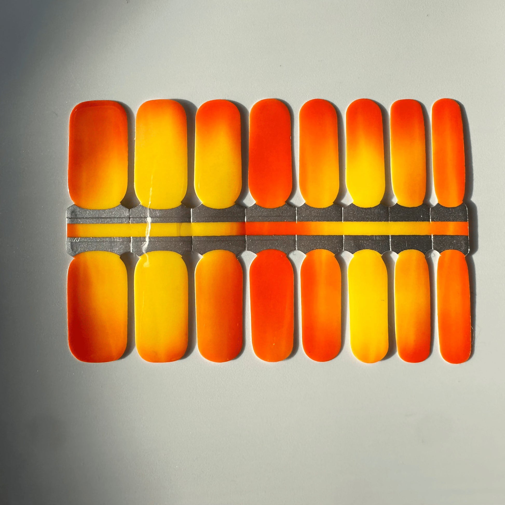Orange yellow gradient nail wraps demonstrating colour-changing thermal nail art effect