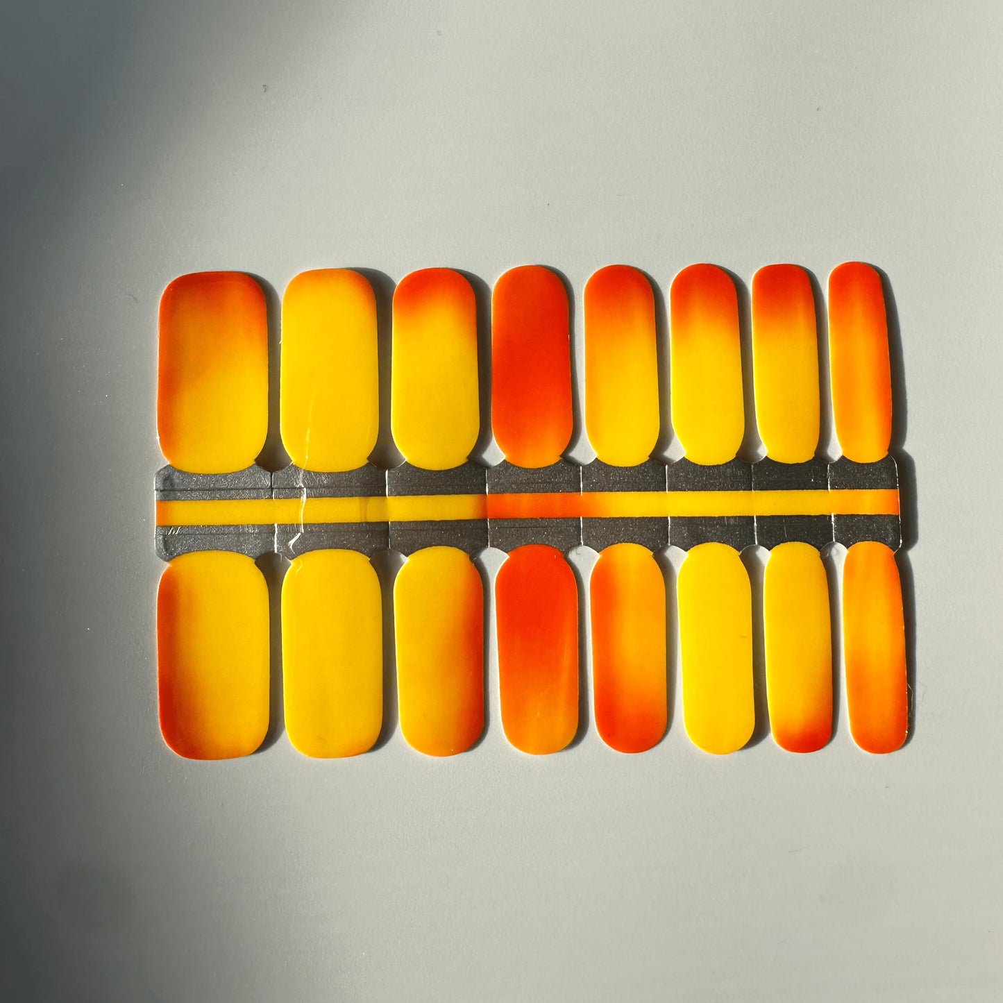 Brick mystique nail wraps showing orange to yellow colour transition effect