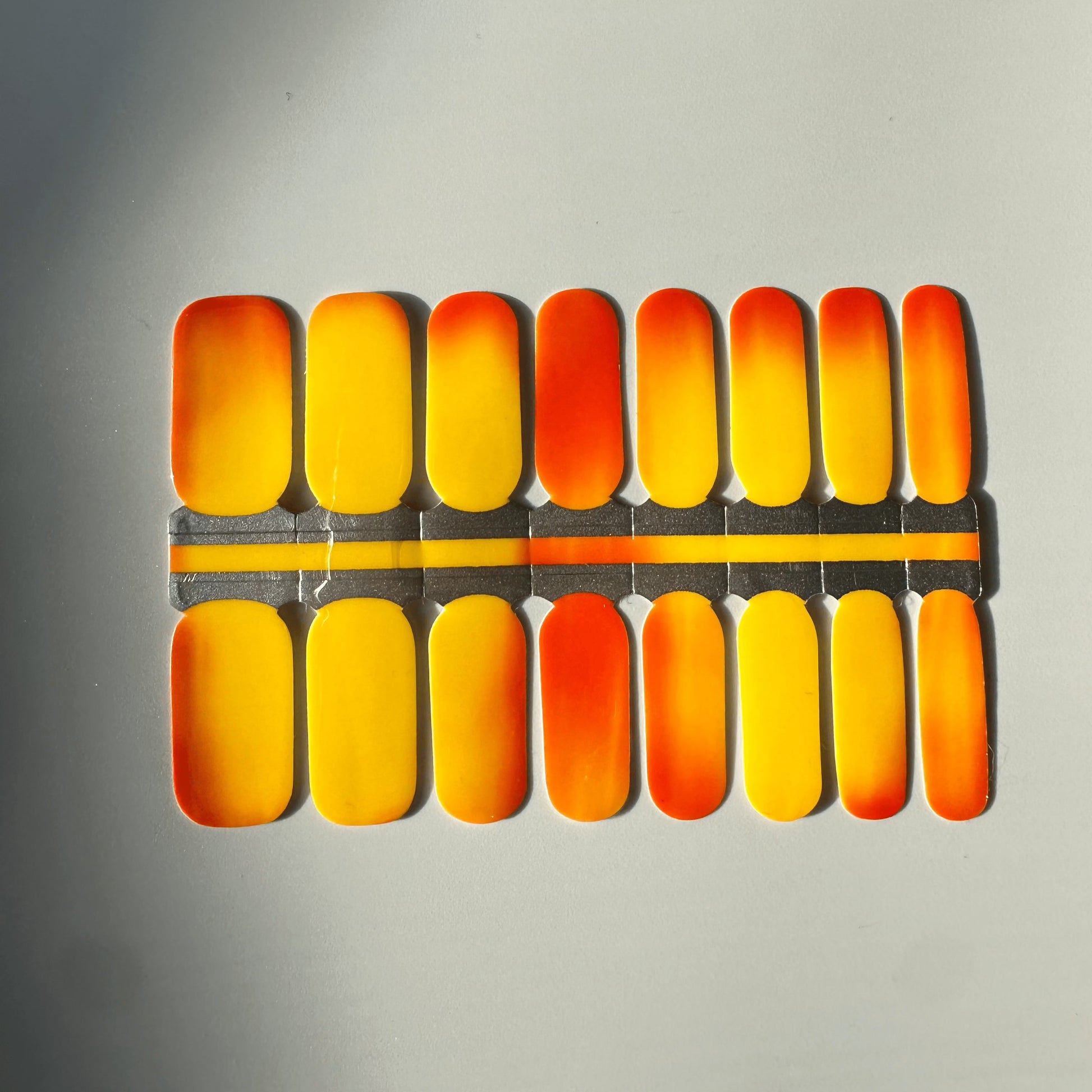 Brick mystique nail wraps showing orange to yellow colour transition effect
