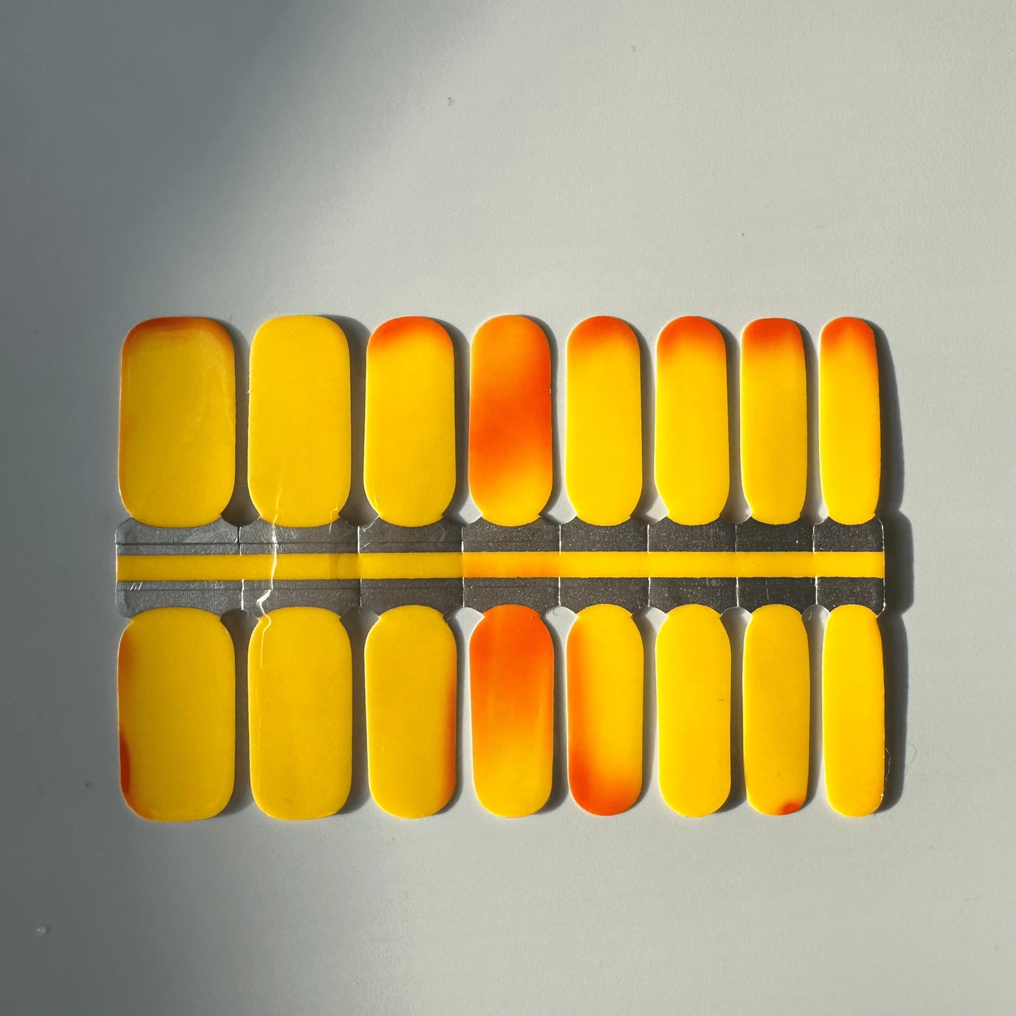 Orange yellow gradient nail wraps in packaging showing colour-changing thermochromic design