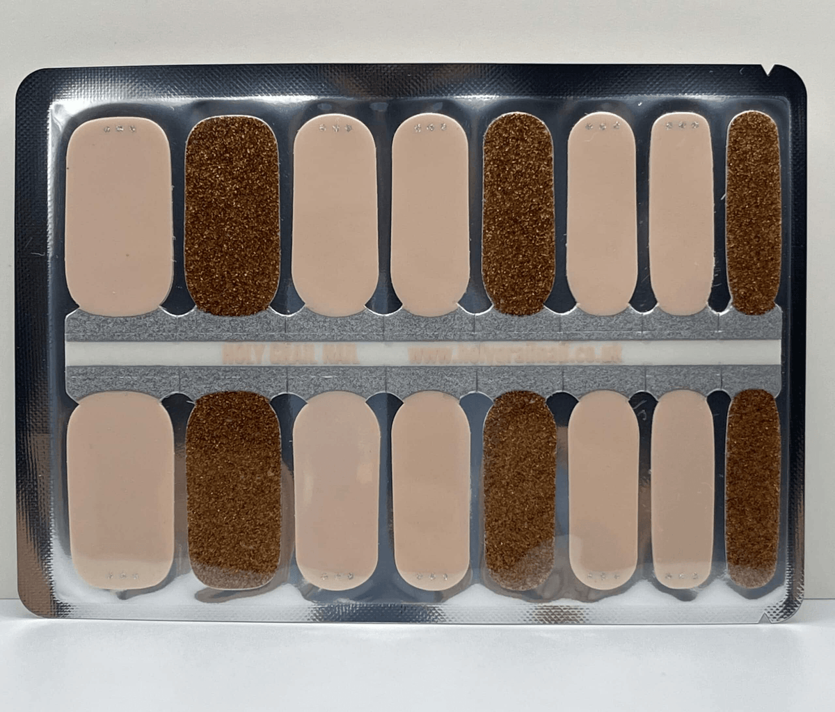 Nude and bronze glitter nail wraps, alternating sheer beige and sparkly copper design
