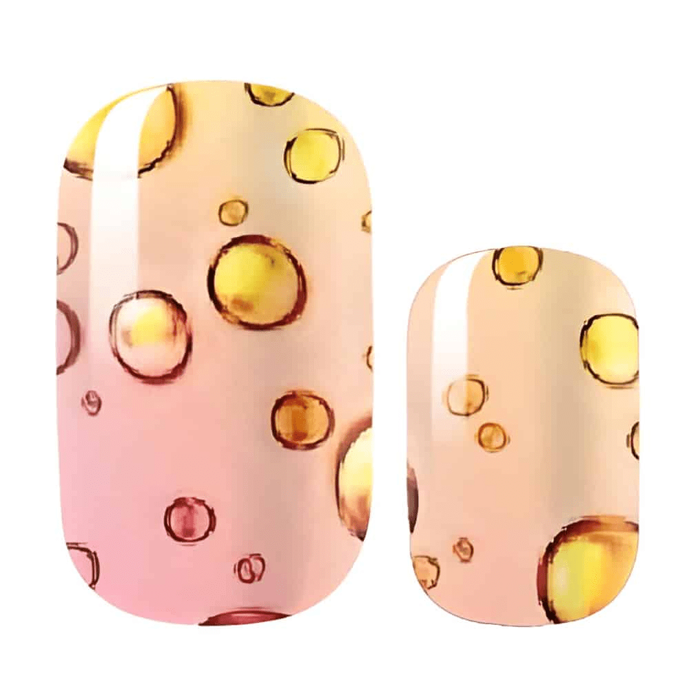 Pink gradient nail wraps with gold bubble pattern for at-home manicures