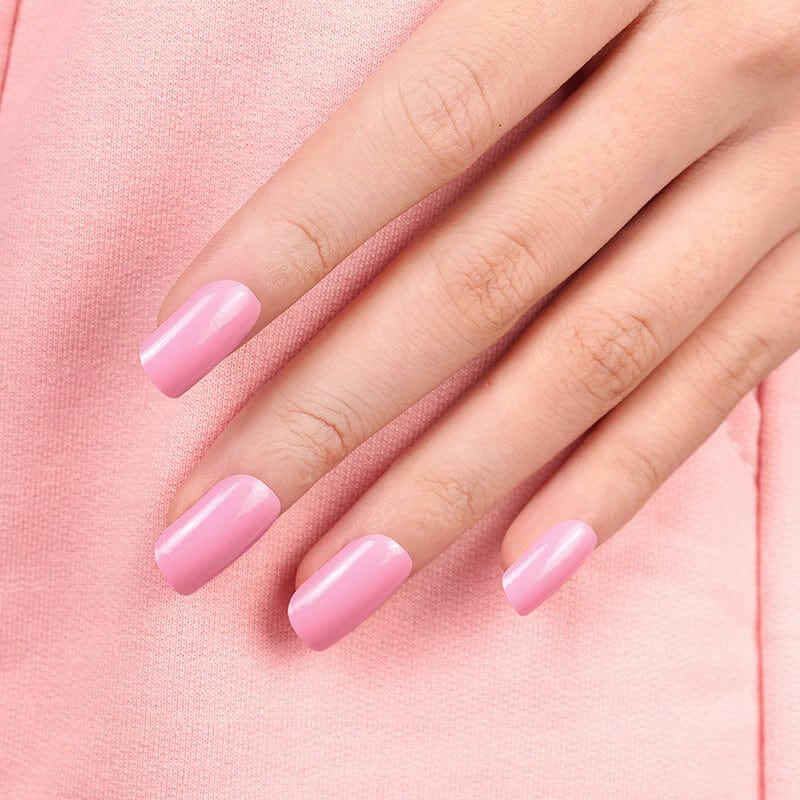 Pink glossy nail wraps on fingertips showing bubblegum manicure detail