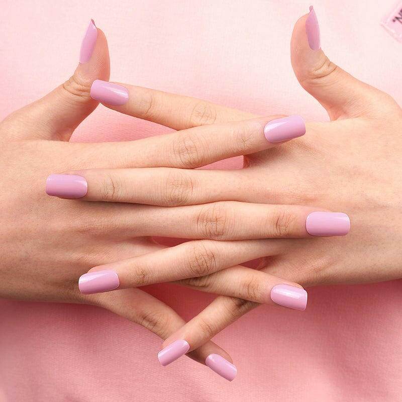 Interlocked hands displaying pink glossy nail wraps for at-home manicure