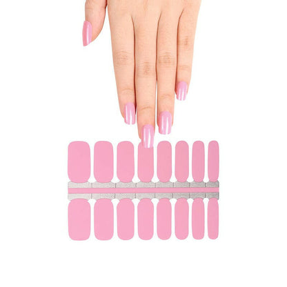 Hand with pink nail wraps next to full sheet of bubblegum coloured nail wraps