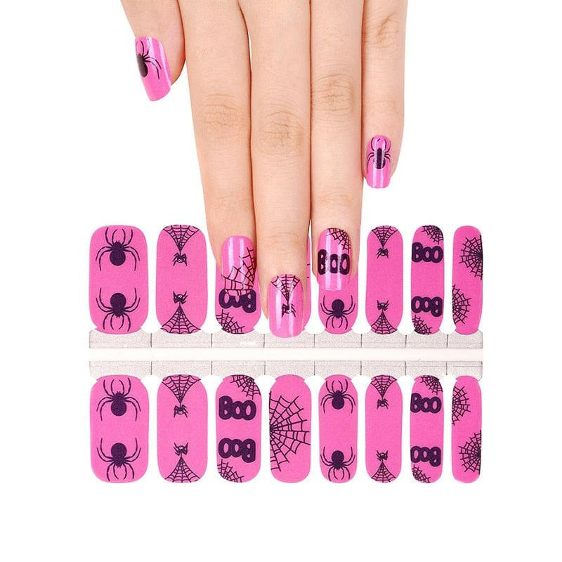 Pink non-UV nail wraps sheet with Halloween spider and cobweb designs for at-home manicure