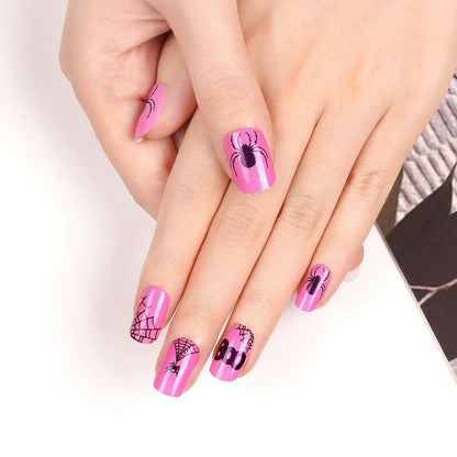Pink Halloween nail art wraps with spiders and web patterns on fingers