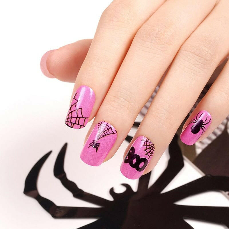 Halloween themed nail wraps in pink with black spider web and BOO designs