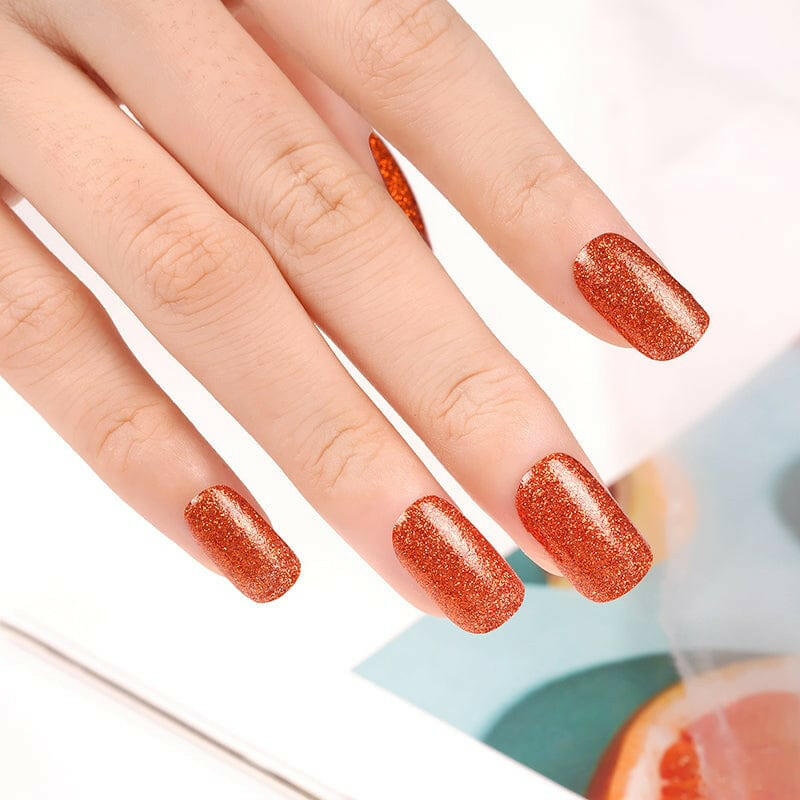 Burnt sienna orange glitter nail wraps with glossy shimmer finish on squoval nails