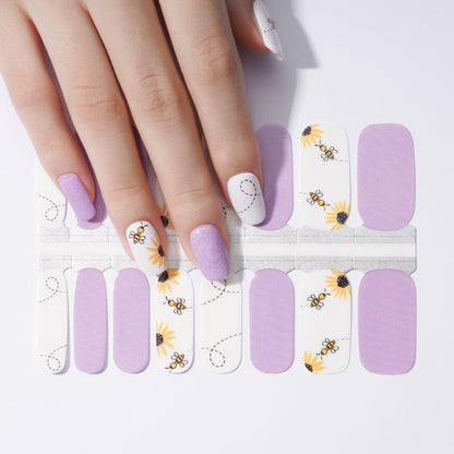 Purple and white bee-themed nail wraps showing manicure design with honeybee pattern