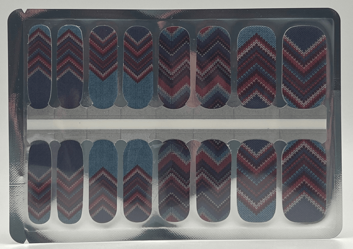 Sheet of cable knit nail wraps featuring blue burgundy chevron geometric patterns
