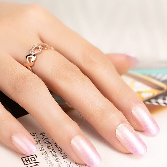 Pearlescent pink ombre nail wraps with soft shimmer on almond-shaped nails