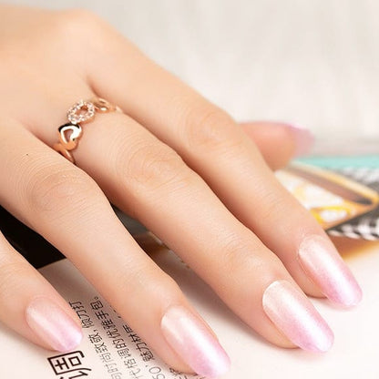 Pearlescent pink ombre nail wraps with soft shimmer on almond-shaped nails