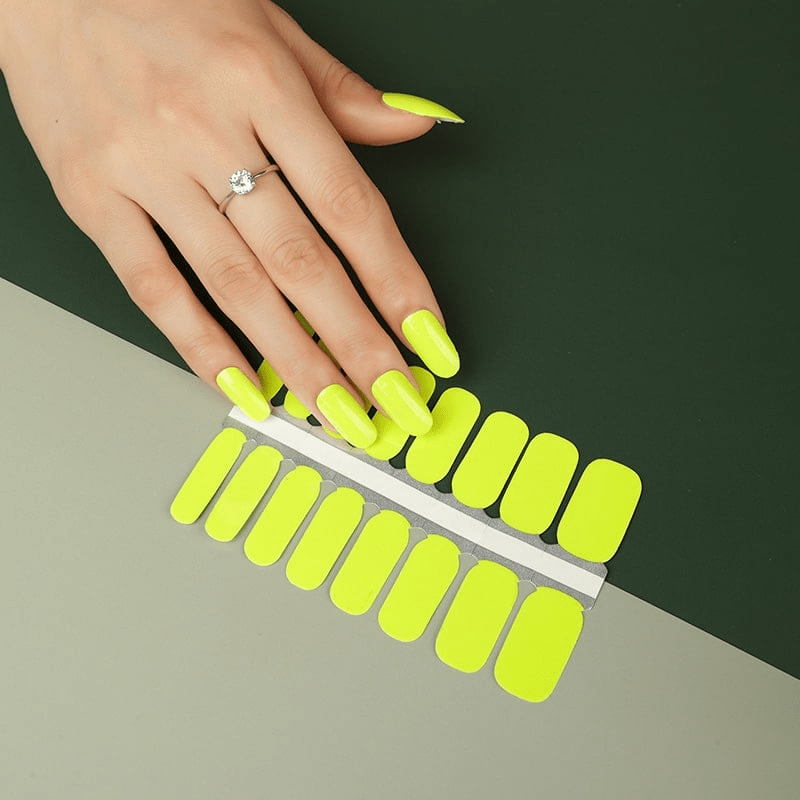 Neon yellow nail wraps sheet with hand showing bright canary coloured nail art