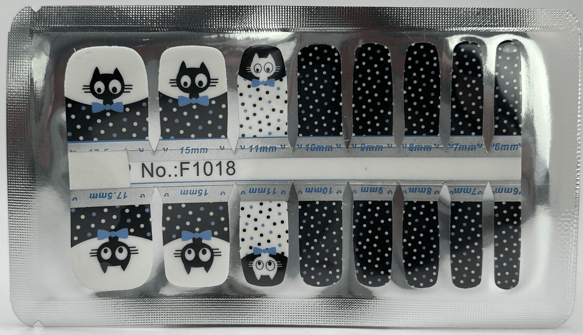 Black and white pedicure nail wraps with cute cartoon cat faces and polka dot patterns