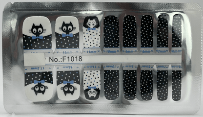 Black and white pedicure nail wraps with cute cartoon cat faces and polka dot patterns