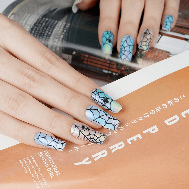 Holographic blue nail wraps with black spider web and spider design, glossy finish