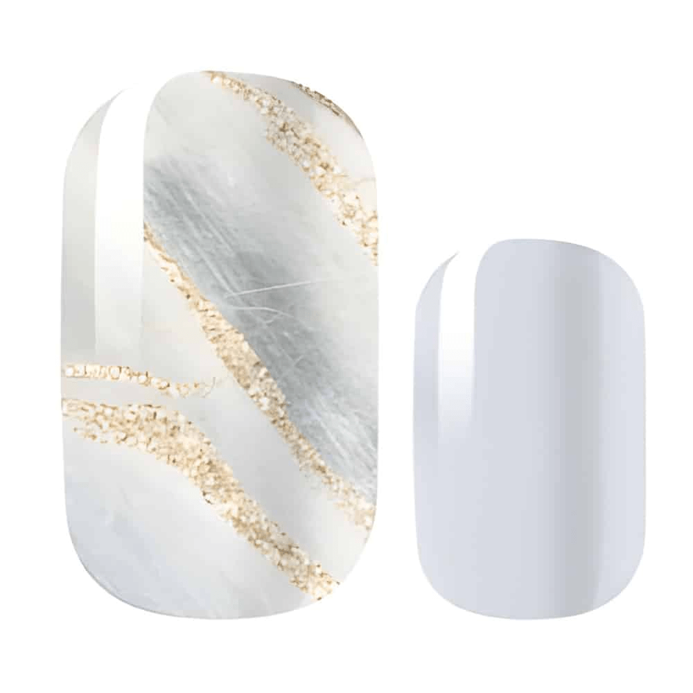 Nail wraps in white-grey marble with gold glitter veins, paired with solid pale grey