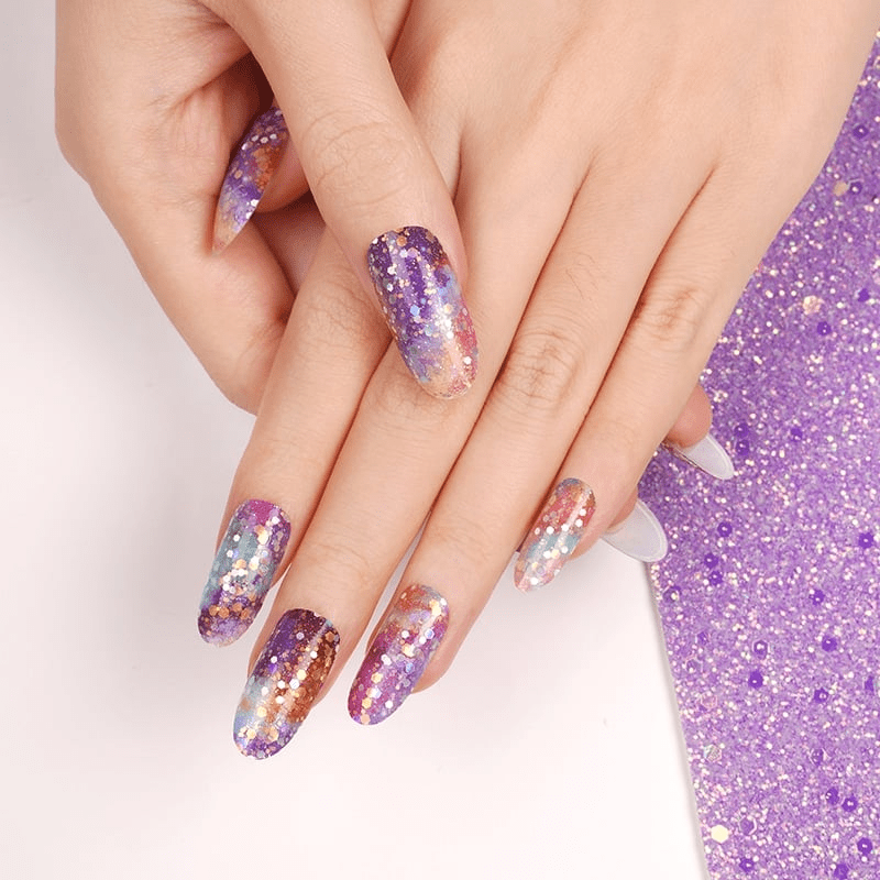 Holy Classics nail wraps in purple, teal and copper galaxy-print with glitter flecks