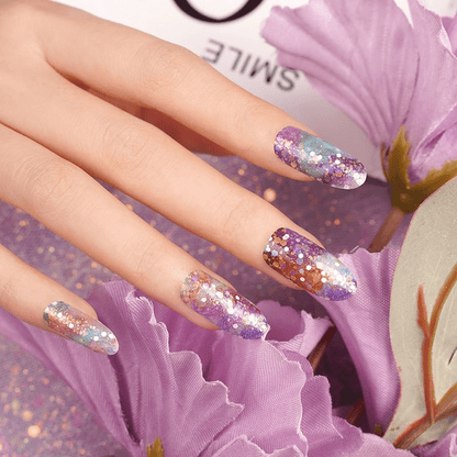 Glittery purple and bronze chunky-glitter nail wraps on long coffin-shape nails