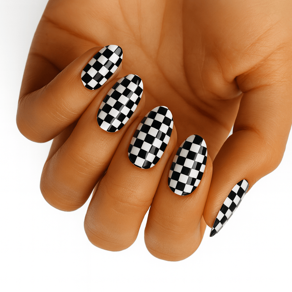 Glossy black and white checkerboard nail wraps on almond-shaped nails