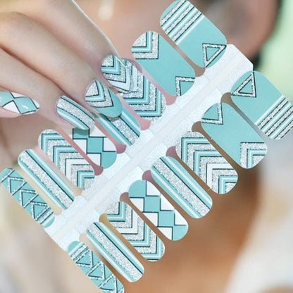 Sheet of mint green chevron nail wraps with white stripes and geometric nail art designs