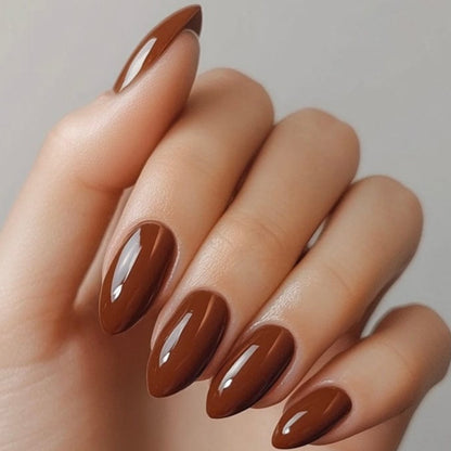 Glossy chocolate brown nail wraps on almond-shaped nails, solid rich finish.