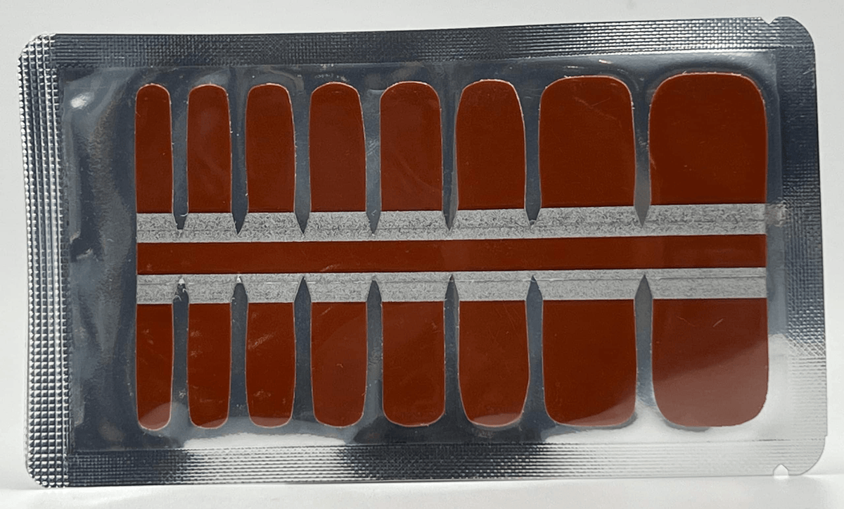 Sheet of brown pedicure nail wraps in various sizes for at-home toe manicures