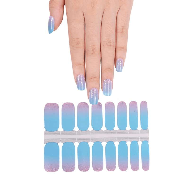 Hand displaying blue pink ombre nail wraps with confetti glitter finish sheet