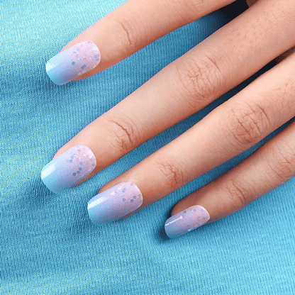 Pastel blue pink ombre nail wraps with glitter confetti pattern on hand