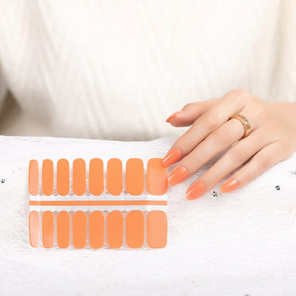 Coral orange nail wraps sheet with hand showing glossy manicure results
