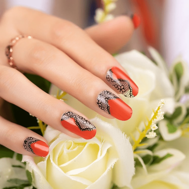 Elegant red and black lace nail art wraps displayed with white roses
