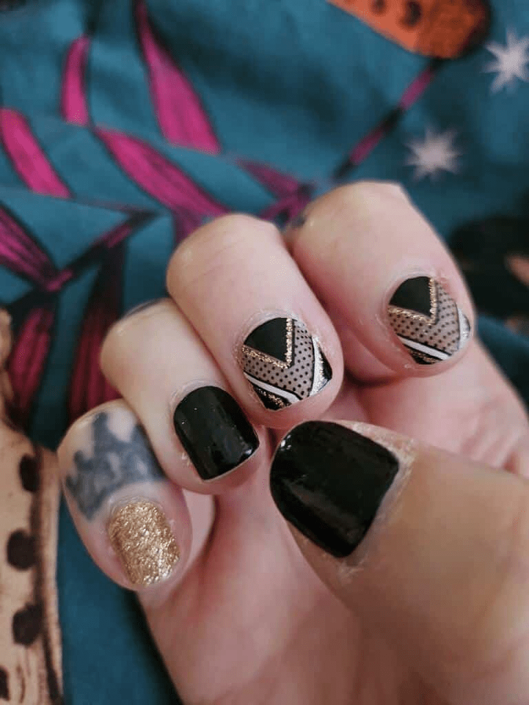 Black nail wraps with gold chevron, polka-dot sheer accents and crown motif
