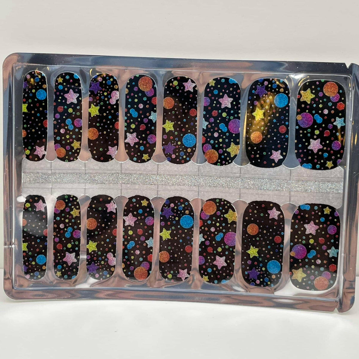 Non-UV nail wraps sheet showing cosmic black design with colourful circles pattern