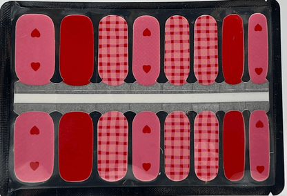 Red and pink gingham check pattern nail wraps with heart accents for Valentine's manicure