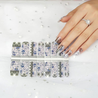 Non-UV nail wraps sheet showing purple floral and black lace crochet patterns